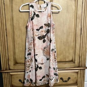 Neutral color dress that sways when you walk.